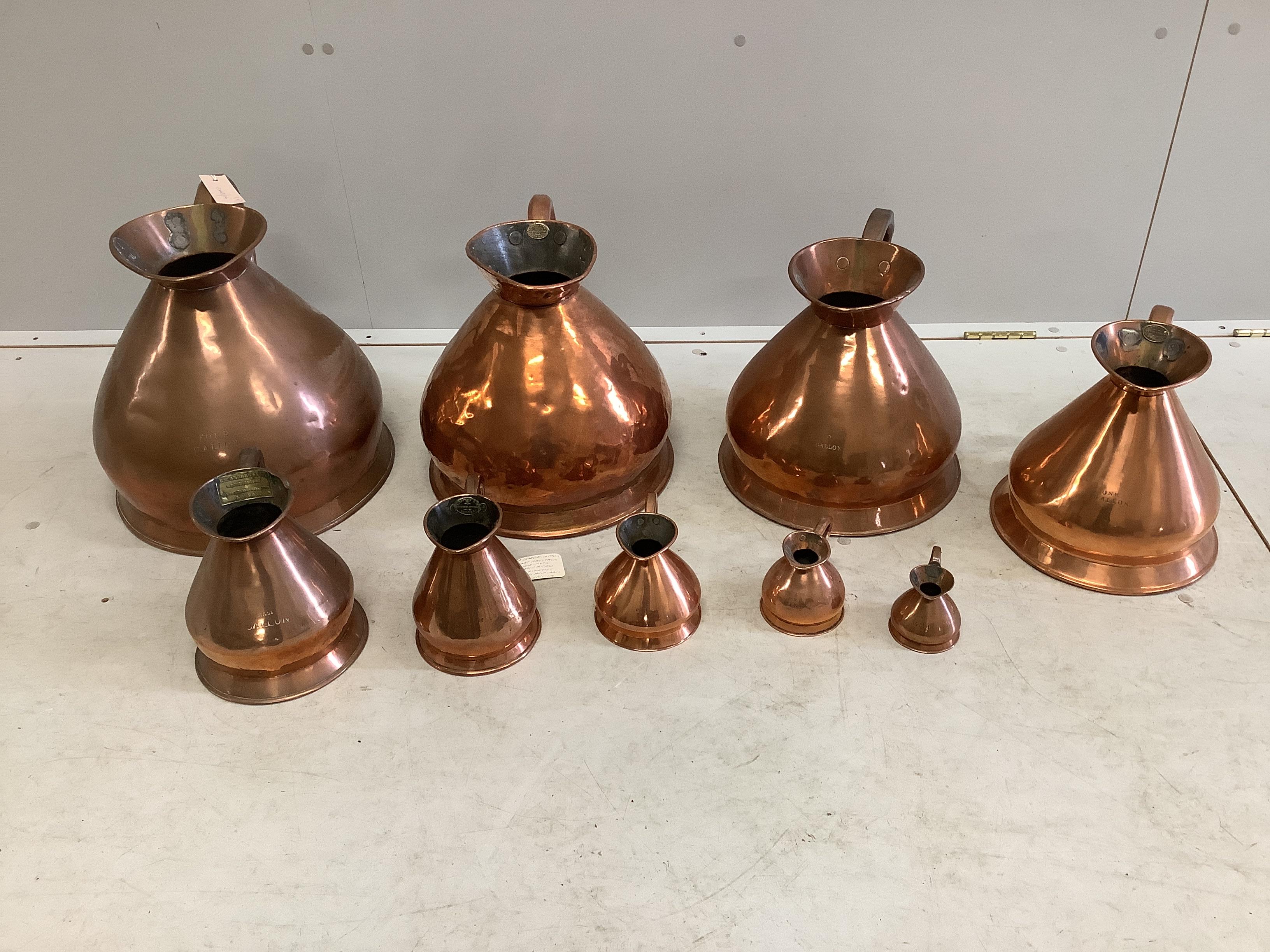 A matched graduated set of nine late 19th / early 20th century copper haystack measures, four gallons to a gill, largest height 36cm
